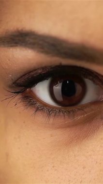 This close-up captures the captivating dark eyes of a young African-American girl, radiating warmth and emotion. Her expressive gaze, framed by flawless skin and delicate features, invites you to explore the beauty and innocence of youth