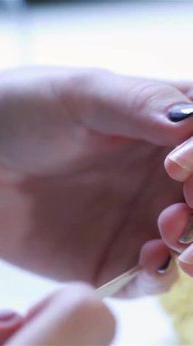 A talented beautician meticulously files a womans nails in an upscale beauty salon, highlighting the artistry of nail care. The scene exudes sophistication and luxury, with vibrant polish and smooth skin reflecting a dedication to beauty and