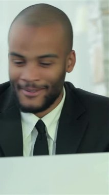 A group of four diverse and smiling businessmen, dressed in sharp formalwear, are animatedly discussing strategies at a sleek, modern office table. Their confident expressions and collaborative spirit create an atmosphere of success and innovation