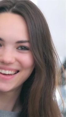 A close-up captures a young, attractive business man and woman sharing an engaging moment as they enthusiastically discuss data on a tablet, their radiant smiles illuminating the modern office backdrop. This vibrant duo exemplifies teamwork and