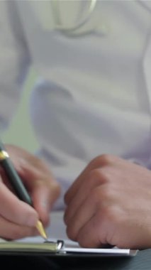 A dedicated doctor in a pristine white coat carefully writes a diagnosis on a clipboard, embodying the essence of compassionate healthcare. The scene radiates professionalism and warmth, highlighting the doctors unwavering commitment to patient care