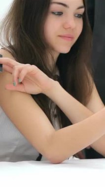 A focused young woman with long dark hair attentively engages with a group of businessmen, holding a credit card as they passionately discuss a potential deal. The atmosphere is electric with collaboration and ambition, highlighting a vibrant