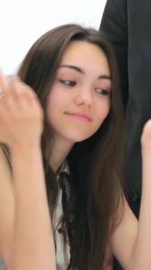 A confident young woman captivates a group of businessmen in a vibrant corporate setting, passionately sharing her ideas. The dynamic atmosphere is charged with energy as her expressive gestures and the attentive listening of the men highlight a