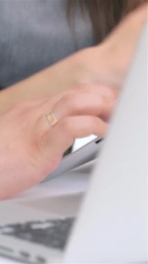 A close-up shot reveals the focused expressions of a young, attractive business man and woman as they passionately analyze data on a sleek tablet. Their dynamic interaction, framed by a modern office environment, exudes professionalism and teamwork