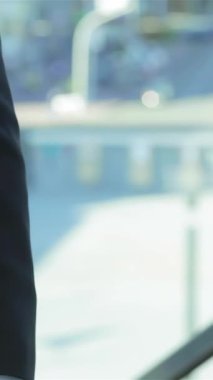 Two professional businessmen, clad in tailored suits, engage in a firm handshake, symbolizing a powerful partnership against a vibrant urban backdrop. The bright cityscape radiates ambition and collaboration, capturing the essence of corporate