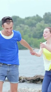 A carefree girl leaps onto her friends back, both bursting with laughter as they sprint along the sun-kissed beach. This lively scene radiates the spirit of friendship and summer joy, with shimmering waves and vibrant greenery framing their playful