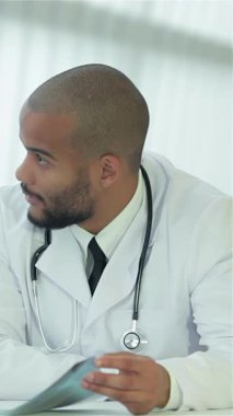 In a sleek, modern hospital setting, a compassionate doctor engages in a meaningful dialogue with a patient, fostering a sense of trust and collaboration. The doctor, sporting a professional white coat and stethoscope, attentively listens as the