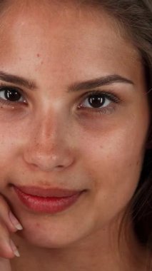 This enchanting studio portrait showcases a charming young woman with long, flowing hair, playfully smiling at the camera against a vivid green chromakey backdrop. Her radiant complexion and joyful expression exude youth and femininity, inviting