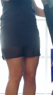 İki neşeli kız, biri şık bir elbise tutuyor, lüks bir koltukta oturuyor, şık kıyafetleri tartışıyor. Işıl ışıl gülüşleri ve canlı ifadeleri parlak bir butik ortamında canlı bir dostluk ve moda keşfi atmosferi yaratır.