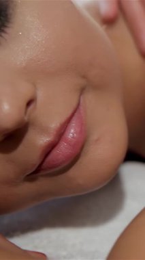 A close-up view of delicate female hands expertly massaging a clients arm, enveloping the scene in a tranquil ambiance. The masseurs skilled thumbs glide effortlessly along the shoulder, enhancing relaxation and promoting a sense of well-being