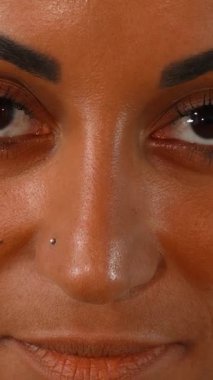 This stunning close-up captures a radiant African woman, her joyful smile illuminating her flawless skin against a lush green backdrop. Her expressive eyes and confident demeanor embody empowerment and a celebration of natural beauty, inviting