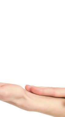 A captivating close-up of a young Caucasian woman gracefully stroking her palms, highlighting the elegance of her delicate fingers. The tranquil ambiance emphasizes her soothing touch, promoting relaxation and self-care against a pristine white