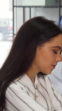 In a sleek, contemporary office, two young female designers passionately brainstorm ideas while collaborating on a laptop, exuding creativity and synergy. Their chic outfits and focused expressions create an inspiring atmosphere, showcasing the