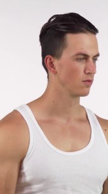 A confident young male athlete lifts his shirt, showcasing his impressive six-pack abs and muscular physique, radiating strength and determination. This dynamic image captures the essence of fitness and bodybuilding, emphasizing the hard work and