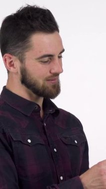 A charming bearded man confidently extends a whimsical toy flower, his warm smile radiating joy and affection. Dressed in stylish attire, he embodies romance and celebration, making this image perfect for Valentines Day or any heartfelt occasion