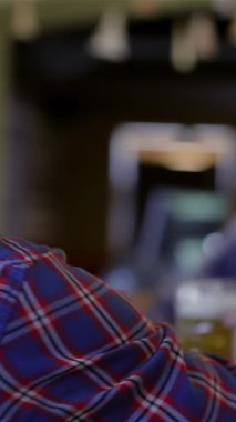 A spirited gathering of male friends revels in the joy of a bachelor party at a lively pub, where laughter and camaraderie create an electric atmosphere. One man raises a frosty beer, the golden liquid glistening in the warm light, embodying their