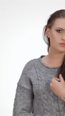 Işıl ışıl, esmer saçlı genç bir kız, el değmemiş beyaz bir fonda neşe içinde poz verirken neşe saçıyor. Neşeli ifadesi ve rahat gri süveteri gençlik enerjisi ve kendine güveni yayıyor. Seyircileri onun tadını çıkarmaya çağırıyor.