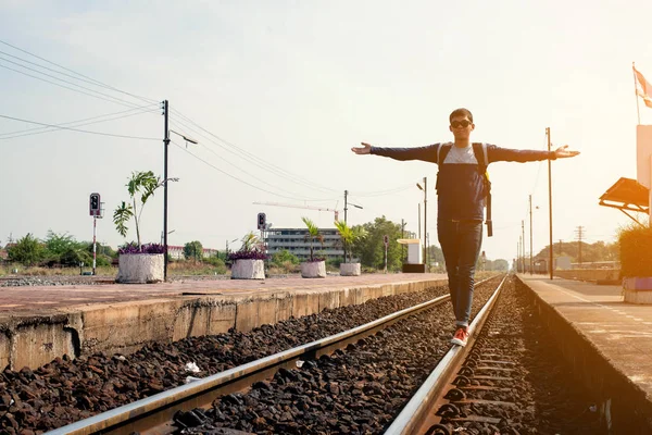 traveler man standing at the train station with a traveler. Travel concept.