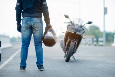 Motosiklet kasklı yakışıklı motosikletçi.