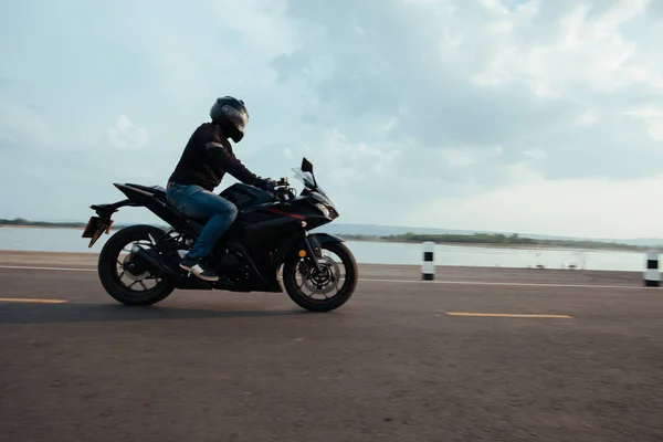 Rider Motorbike on the road riding. having fun driving the empty