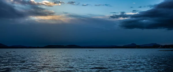 Lake Constance at the blue hour with beautiful cloud mood Hohentwiel panorama view