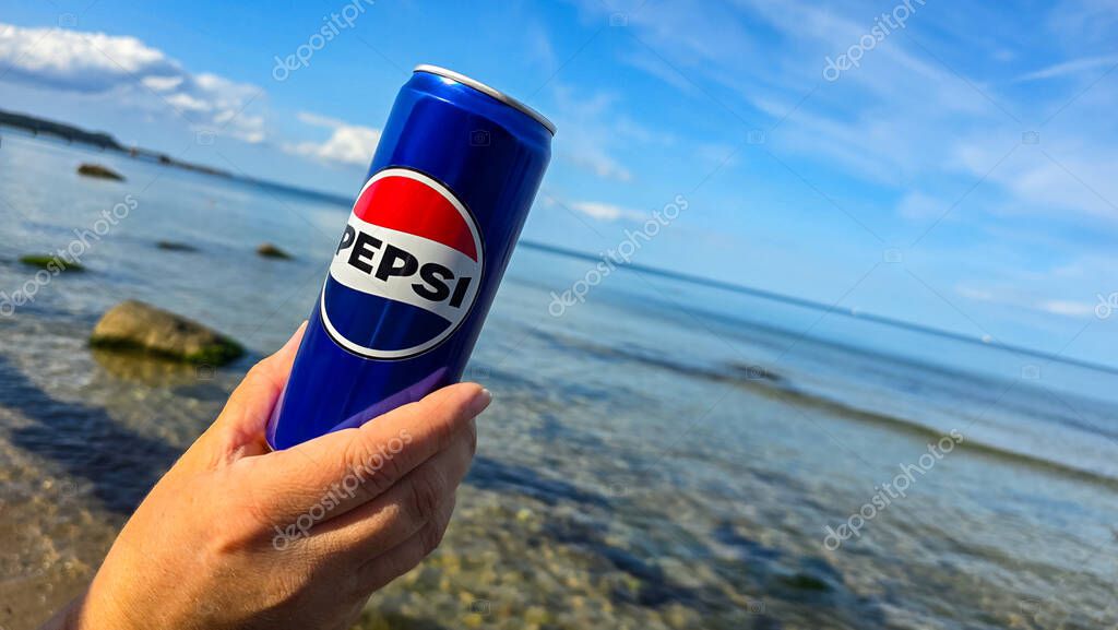 Woman Hand holding Pepsi can with ocean background on the Baltic Sea on September 4, 2025