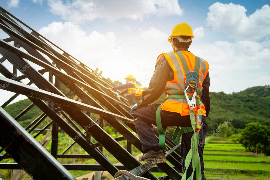 Asian worker wear safety height equipment to install the roof. Fall arrestor device for worker with hooks for safety body harness, Worker as in the construction sit