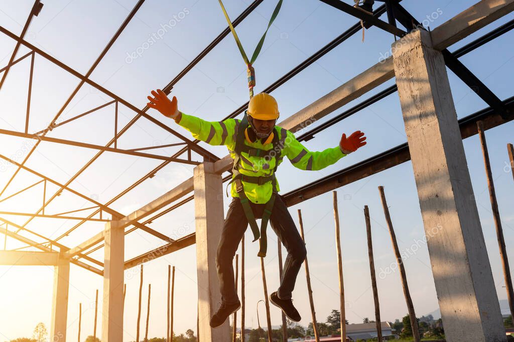 Construction workers fall from a height but have safety to help. Concept of preventing danger from heights with Safety on the construction site.