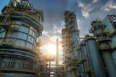 Petrol ve gaz rafinerisi sanayi bölgesinin güneş doğuşu ve bulutlu gökyüzü, petrol ve gaz endüstrisi konseptiyle sanayi görünümünü kapatın.