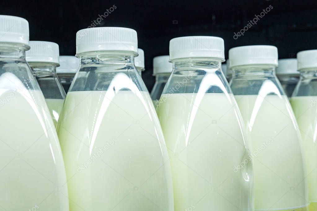 Bottles of milk close up, show on a shelf for sale in a supermarket