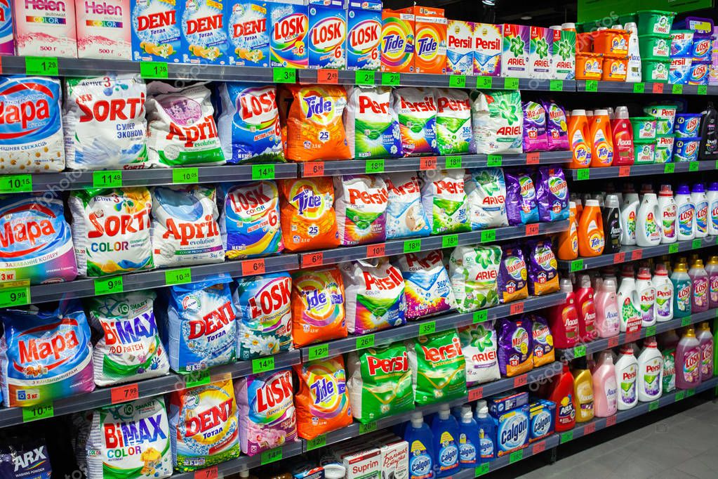 MINSK, BELARUS - August 21, 2019: Supermarket display with different brands of washing powder (Persil, Ariel, Losk, Tide, Deni, April).