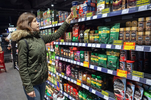 MINSK, BELARUS - October 4, 2019: Shopper chooses coffee in the supermarket.