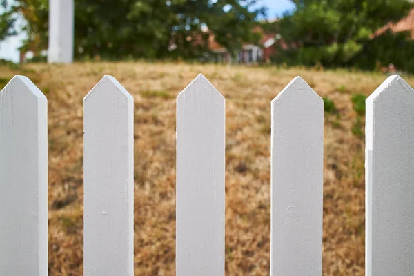 Closeup of a white-picket fence