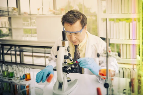 Professor testing chemistry in lab