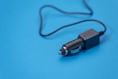 Araba şarj cihazı araç adaptörü üzerinde mavi arka plan izole çakmak için