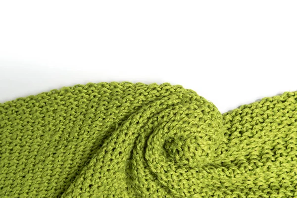 Wool blanket, green, knitted large chunky yarn. Close-up of knitted blanket on white background.