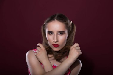 Güzel tabaklanmış model parlak makyaj ve mükemmel deri kırmızı bir arka plan üzerinde poz ile