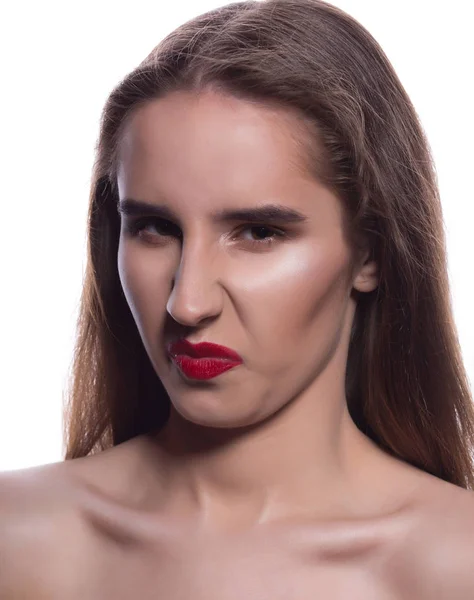 Closeup portrait of smirking brunette woman with bright makeup, posing on a white background