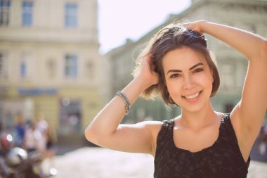 Sokakta yürürken bronz ten rengi ve doğal makyaj ile keyifli esmer kadın. Boş alan