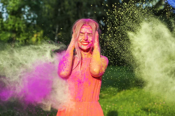 Playful Blonde Woman Exploding Colorful Paint Celebrating Holi Festival — Stock Photo, Image