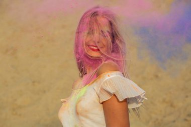 Pembe ve mavi kuru boya Holi çölde, bir bulut poz duygusal sarışın kadın
