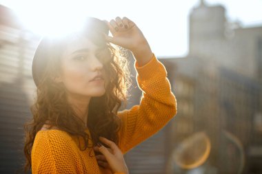 Trendy giyim güneş ışınlarının poz giyen moda esmer kadın sokak portresi. Boş alan