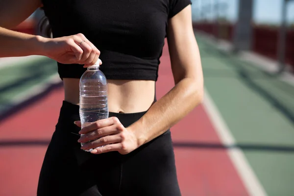 Young Athletic Woman Opening Water Bottle Jogging Bridge Space Text — Stock Photo, Image