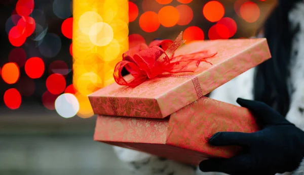 Closeup Shot Female Hands Gloves Holding Gift Box Background Red — Stock Photo, Image