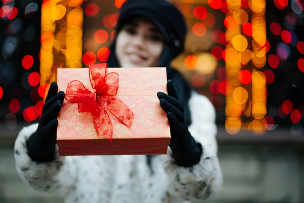 Cheerful Young Woman Wearing Fur Coat Cap Pulls Gift Box — Stock Photo, Image