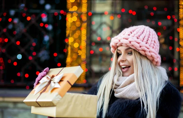 Surprised Blonde Girl Wearing Knitted Cap Warm Coat Holding Gift — Stock Photo, Image