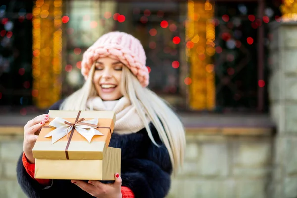 Lovely Blonde Woman Wearing Knitted Cap Warm Coat Holding Gift — Stock Photo, Image