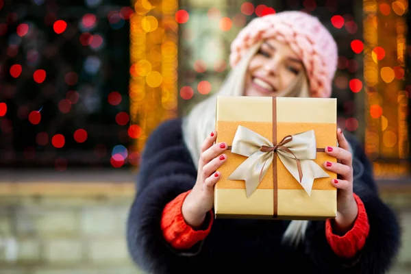Charming Young Woman Wearing Fur Coat Cap Pulls Gift Box — Stock Photo, Image