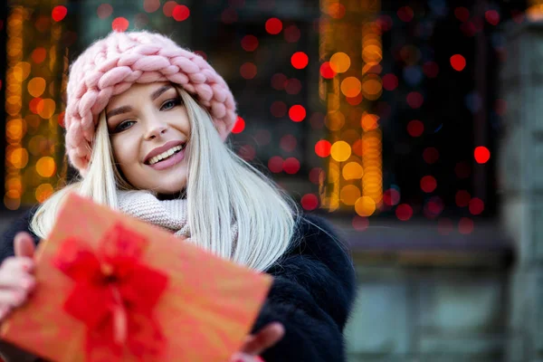 Delightful Blonde Woman Wearing Fur Coat Knitted Cap Pulls Gift — Stock Photo, Image