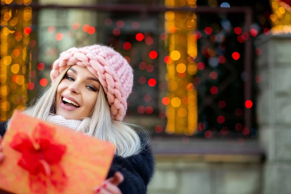 Emotional Young Woman Wearing Fur Coat Cap Pulls Gift Box — Stock Photo, Image